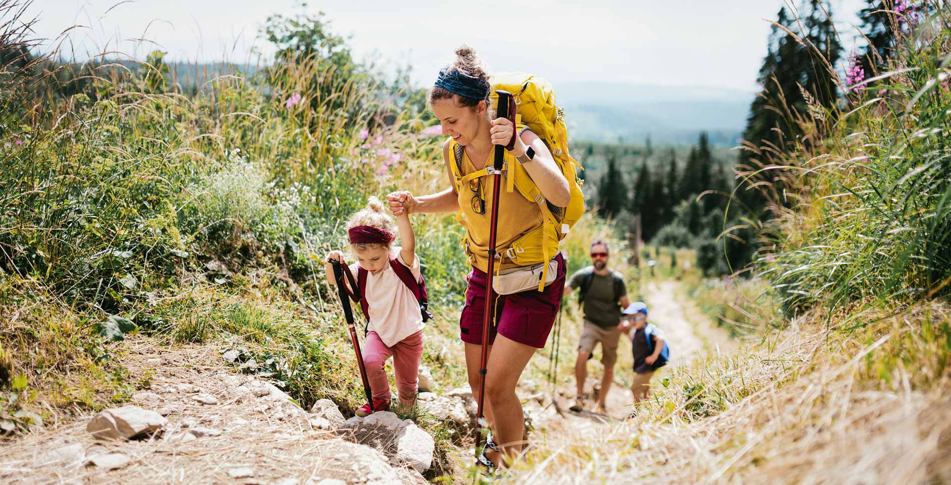 A family of four goes on a hiking trip in the natural surroundings of Hinterstoder.