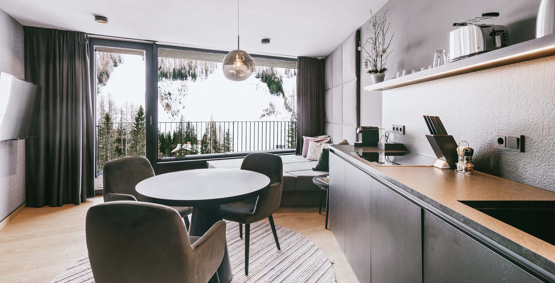 1 bedroom Superior Suite “Almkogel” at the TRIFORÊT alpin.resort with a view of the snowy Hinterstoder region.