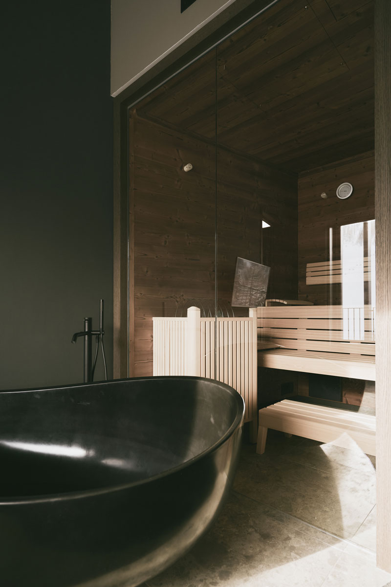 Sauna and freestanding bathtub in the bedroom of the Deluxe Penthouse Suite at the TRIFORÊT alpin.resort.
