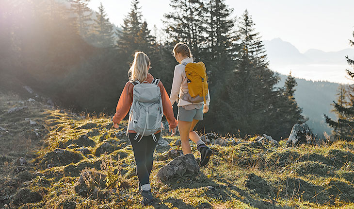 Wanderung durch die alpine Natur bei strahlendem Sonnenschein im Sommerurlaub im TRIFORÊT alpin.resort in den Alpen.